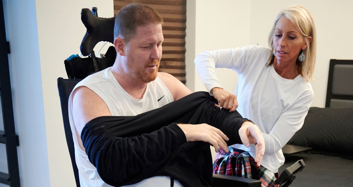 Shawn Bradley in wheelchair with his wife Carrie